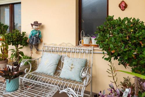 a white bench sitting on a porch with plants at Il Dolce Risveglio in Fossacesia