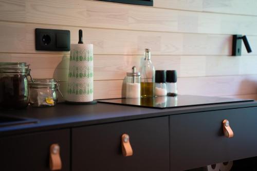 a counter top with bottles on it in a kitchen at Chic Sauna Cabin Near the Sea - MULIN Cabin Nº05 in Tsitre