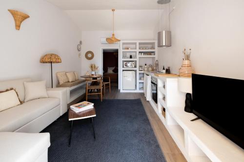 a living room with a couch and a table at Casinha Rosalia Carrasqueira in Comporta