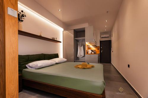 a small bedroom with a bed in a room at Nemausa Luxury Living in Kallithea Halkidikis