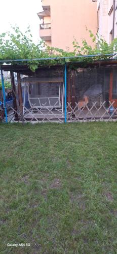 a fence in the grass in a yard at Къща за гости ЕДЕЛВАЙС in Chernomorets