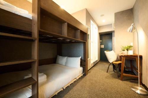 a bedroom with a bunk bed with a desk and a chair at Sapporo - Apartment - Vacation STAY 29222v in Sapporo