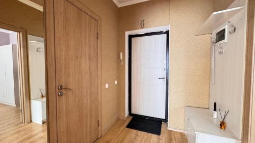 a hallway with a white door in a room at EmmaApart Comfort 169 in Astana