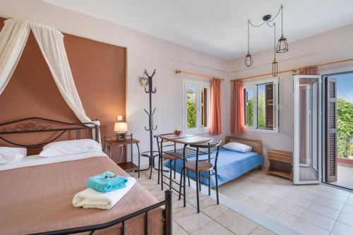 a bedroom with two beds and a table at Christianna studios in Nikiana