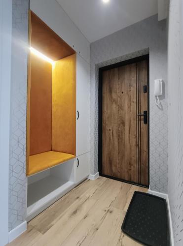 a room with a wooden door and a wooden floor at Apartament Kotlina in Kłodzko