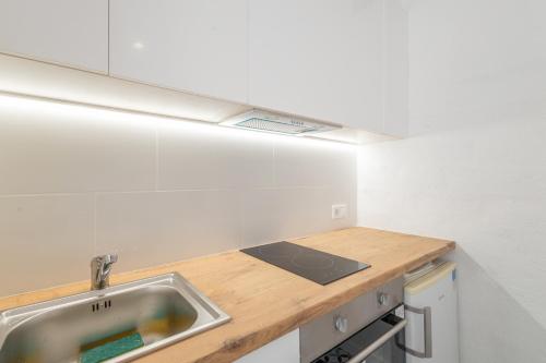 a kitchen with a sink and a counter at Portblanc Loft in Arenys de Mar