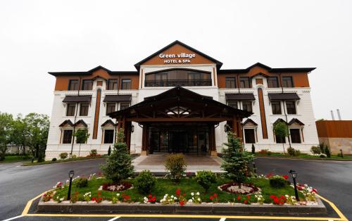 a large building with flowers in front of it at Green Village HOTEL & SPA in Sis