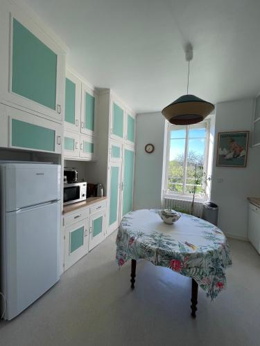 a kitchen with a table and a window in it at Charming country house 