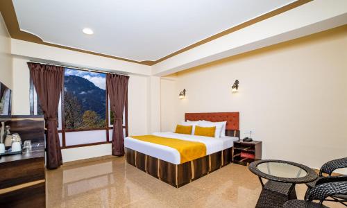 a bedroom with a bed and a window at Sumitel Sonam Lachung in Lachung