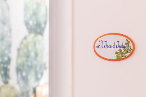 a door sign on a door with a window at The Garden in Maiori