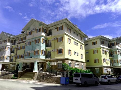 ein großes Gebäude, vor dem Autos parken in der Unterkunft Apple One Banawa Heights in Cebu City