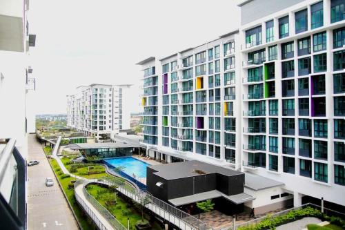 a large building with a pool in front of it at Jazz Suite Vivacity Kuching in Kuching