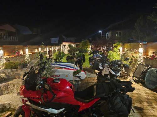 a group of motorcycles parked in a yard at night at Villa Natali in Ohrid