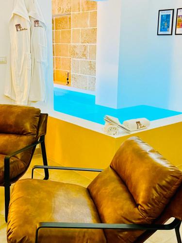 a waiting room with two leather chairs at Corte Gabellone - dimora storica in Nardò