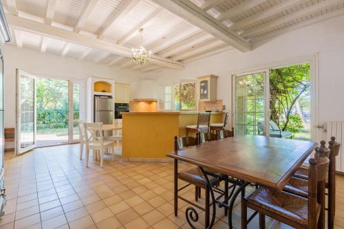 une cuisine et une salle à manger avec une table et des chaises dans l'établissement Le Mas des Trois Sources - Grand jardin, à Gignac
