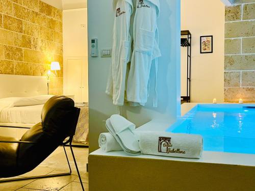 a hotel room with a bed and a swimming pool at Corte Gabellone - dimora storica in Nardò