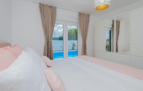 a person is making a bed in a bedroom at Villa Kristina - Makarska by Villas Guide in Donji Proložac
