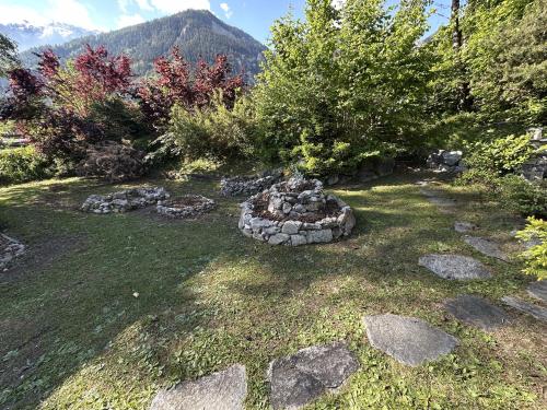 a garden with a pile of rocks in the grass at WoodMood in Leuk