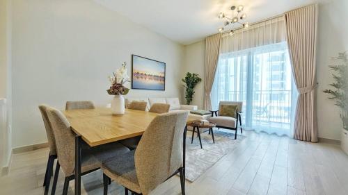 a dining room with a wooden table and chairs at Glamorous 2bd Apt Yas Island in Abu Dhabi