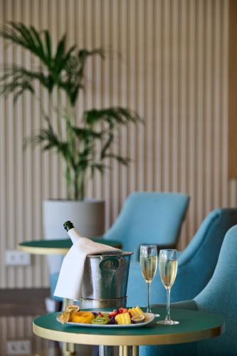 a table with two glasses of wine and a plate of food at Hipotels Playa de Palma Palace&Spa in Playa de Palma