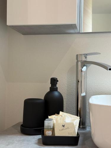 a bottle of soap on a counter next to a sink at Il Monastero di Qua in Sarturano