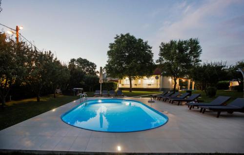 a large swimming pool with lounge chairs around it at Villa Ante - Makarska by Villas Guide in Gornja Glavina