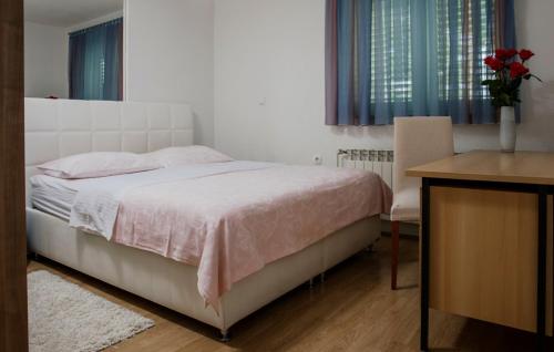 a bedroom with a bed and a table and a desk at Villa Ante - Makarska by Villas Guide in Gornja Glavina
