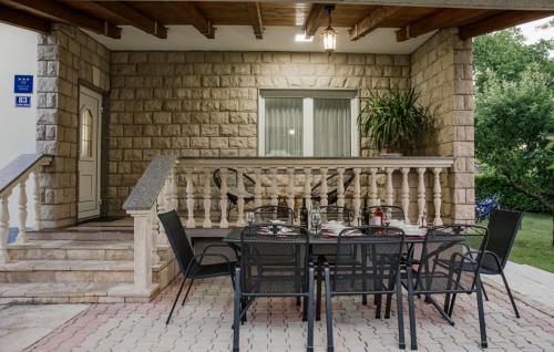 a patio with a table and chairs on a porch at Villa Ante - Makarska by Villas Guide in Gornja Glavina