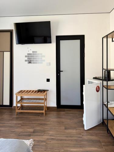 a room with a door and a table and a refrigerator at Шишка in Bukovel