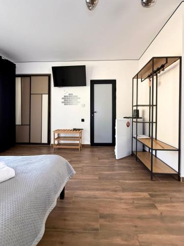a white room with a bed and a kitchen at Шишка in Bukovel
