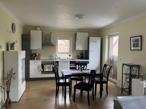 eine Küche und ein Esszimmer mit Tisch und Stühlen in der Unterkunft Comfy & Cozy Apartment in Neuenhagen