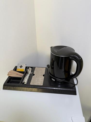 a black coffee cup sitting on a black tray at Шишка in Bukovel