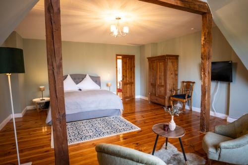 a bedroom with a bed and a living room at Gut Alt Necheln in Brüel