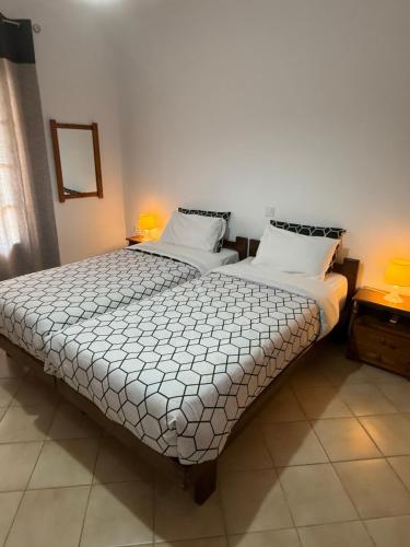 a bedroom with two beds with white sheets at Evita Luxury Apartments in Spilia