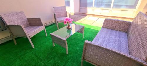 a room with purple chairs and a table with a candle at Lumen Triplex by Oshun LOFTS & MIDSTAY in Madrid