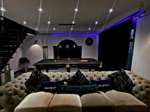 a living room with a couch and a pool table at Luxury 4 Bed Room House, Heathrow in Colnbrook