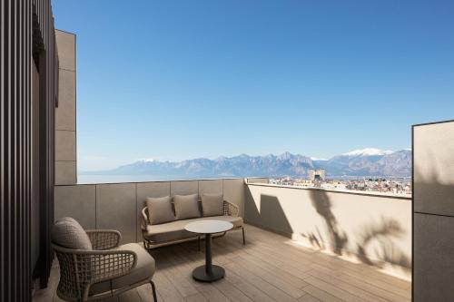 a balcony with a table and chairs and a view at Residence Inn by Marriott Antalya in Antalya