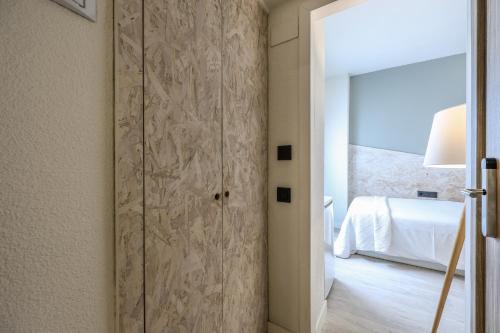 Ένα ή περισσότερα κρεβάτια σε δωμάτιο στο Habitaciones Atocha Rio