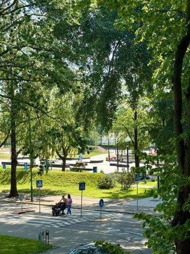 a group of people sitting in a park at Central Antique Gallery Apartment self-check in in Klaipėda