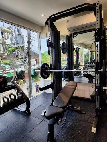 a gym with a chair in front of a window at Baan Bophut Beach Hotel Samui - SHA Extra Plus in Bophut 
