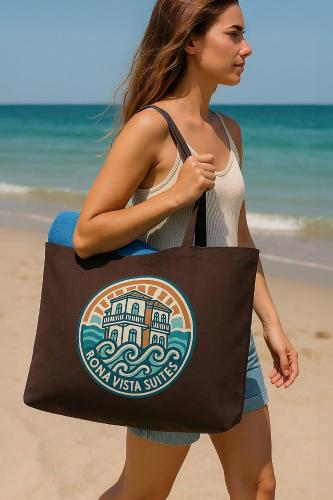 a woman holding a bag on the beach at Rona Vista Suites amazing seaview 2 in Polykhrono