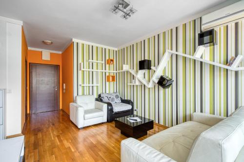 a living room with a couch and a chair at Studio apartment in the centre of Budva in Budva