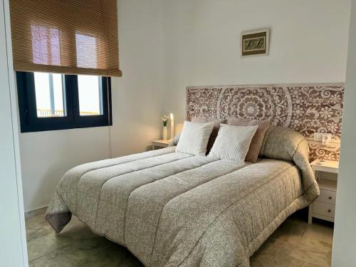 Postel nebo postele na pokoji v ubytování Ático Juan Grande 15 by Sanlúcar Housing