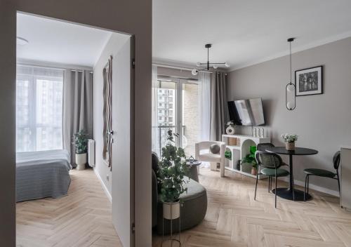 a living room with a bed and a dining room at Baltic Sands Apartment- 15 min Beach Free Parking Premium Letnica in Gdańsk