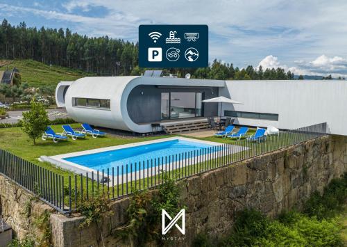 a house with a swimming pool next to a building at MyStay - Varanda de Basto in Canedo de Basto