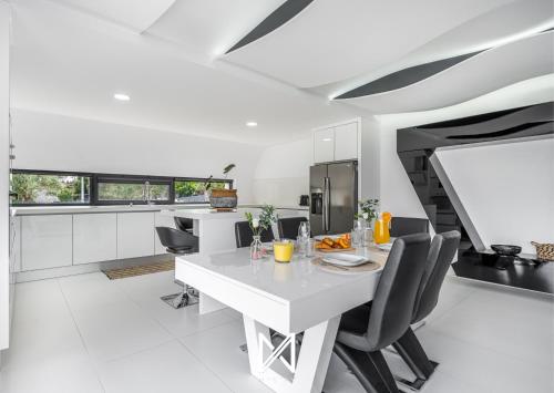 a white kitchen with a white table and chairs at MyStay - Varanda de Basto in Canedo de Basto