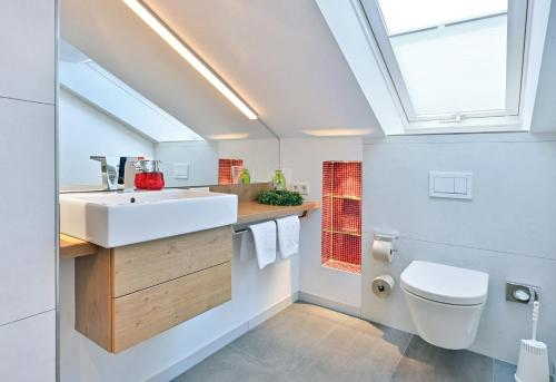 a bathroom with a sink and a toilet at Landhaushotel Hof Wasserkuppe in Poppenhausen