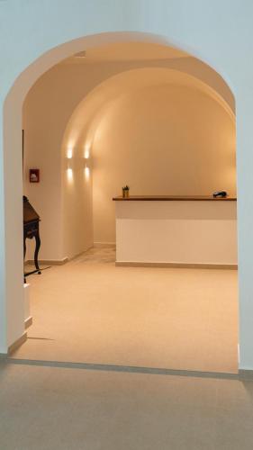 an archway with a piano in a room at La Grotta in Volimes