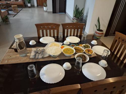 a table with plates and bowls of food on it at Sublime Homestay in Bhubaneshwar
