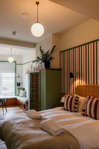 a bedroom with two beds in a room at The London & Paris Hotel in Folkestone